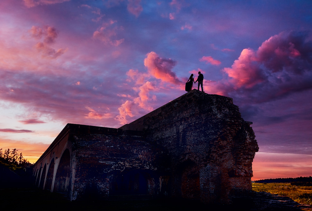 Timber+Alec on top of the wall with epic sunset during their Ft. Pickens Sunset Engagement Session, Timber+Alec, Ft. Pickens Sunset Engagement Session, Pensacola engagement photographer, Pensacola engagement photo session, Pensacola engagement photos, Pensacola engagement photography, Lazzat Photography