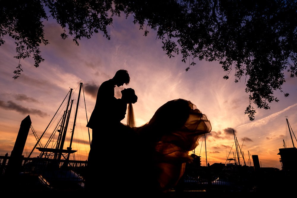 Bride and Groom silhouette at sunset with sailboats, Romantic Catholic Wedding, Pensacola Florida Wedding Photographer, Lazzat Photography