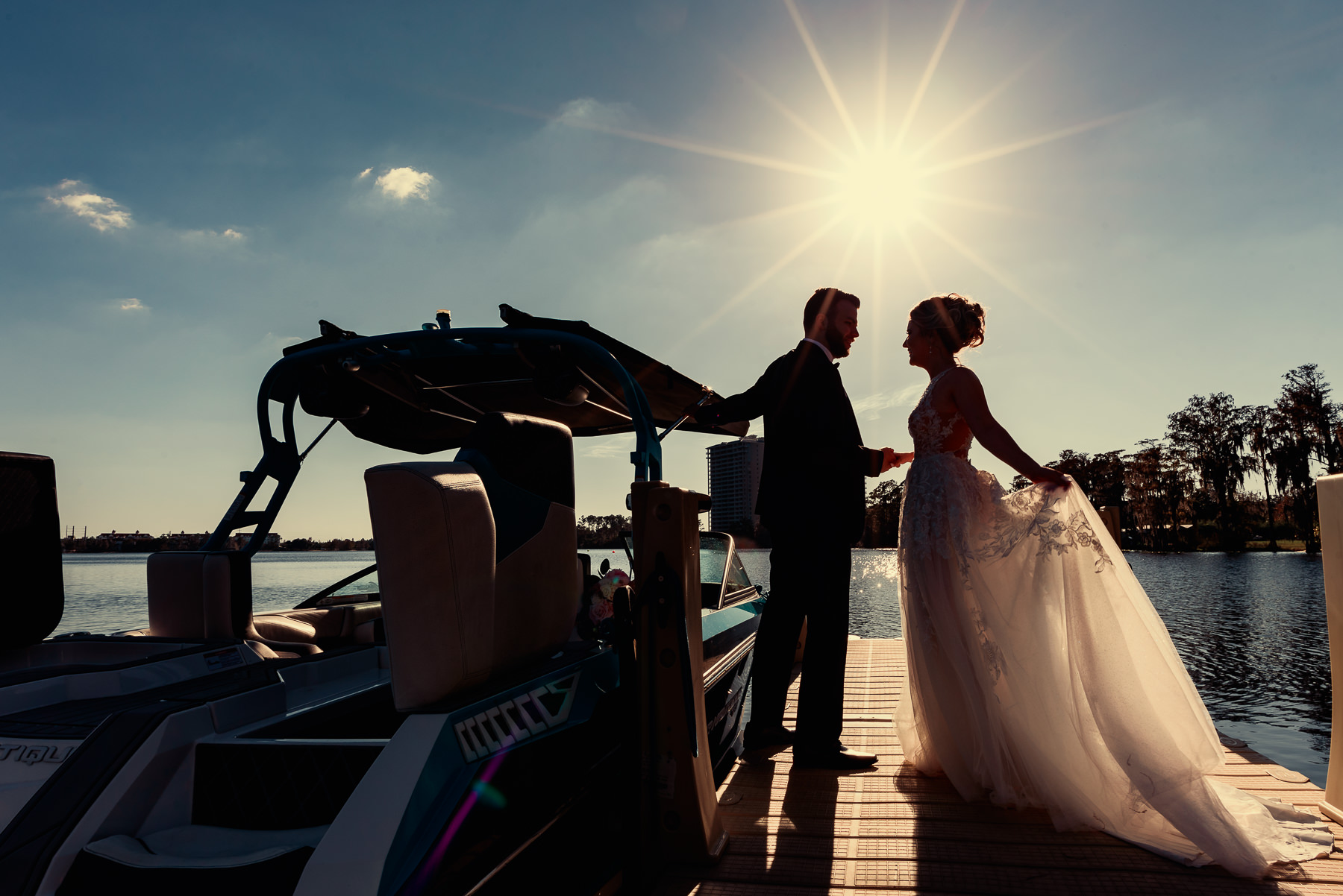 Paradise Cove Orlando Wedding | bride and groom posing next to boat
